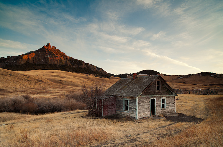 The light of sunset casts a warm glow on this abandoned homestead in Cascade County, Montana.