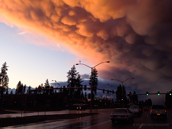 The sunset lights up mammatus clouds as seen driving in Coeur d'Alene Idaho.